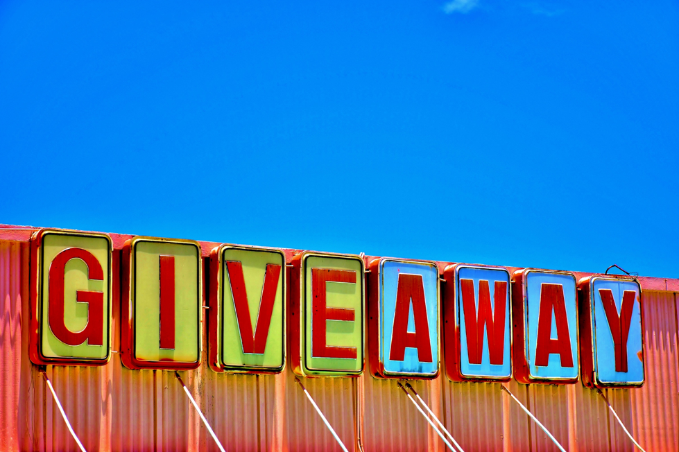 Giveaway sign on top of building